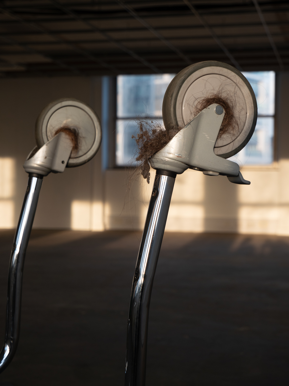 detail of trolley wheel with human hair and filth